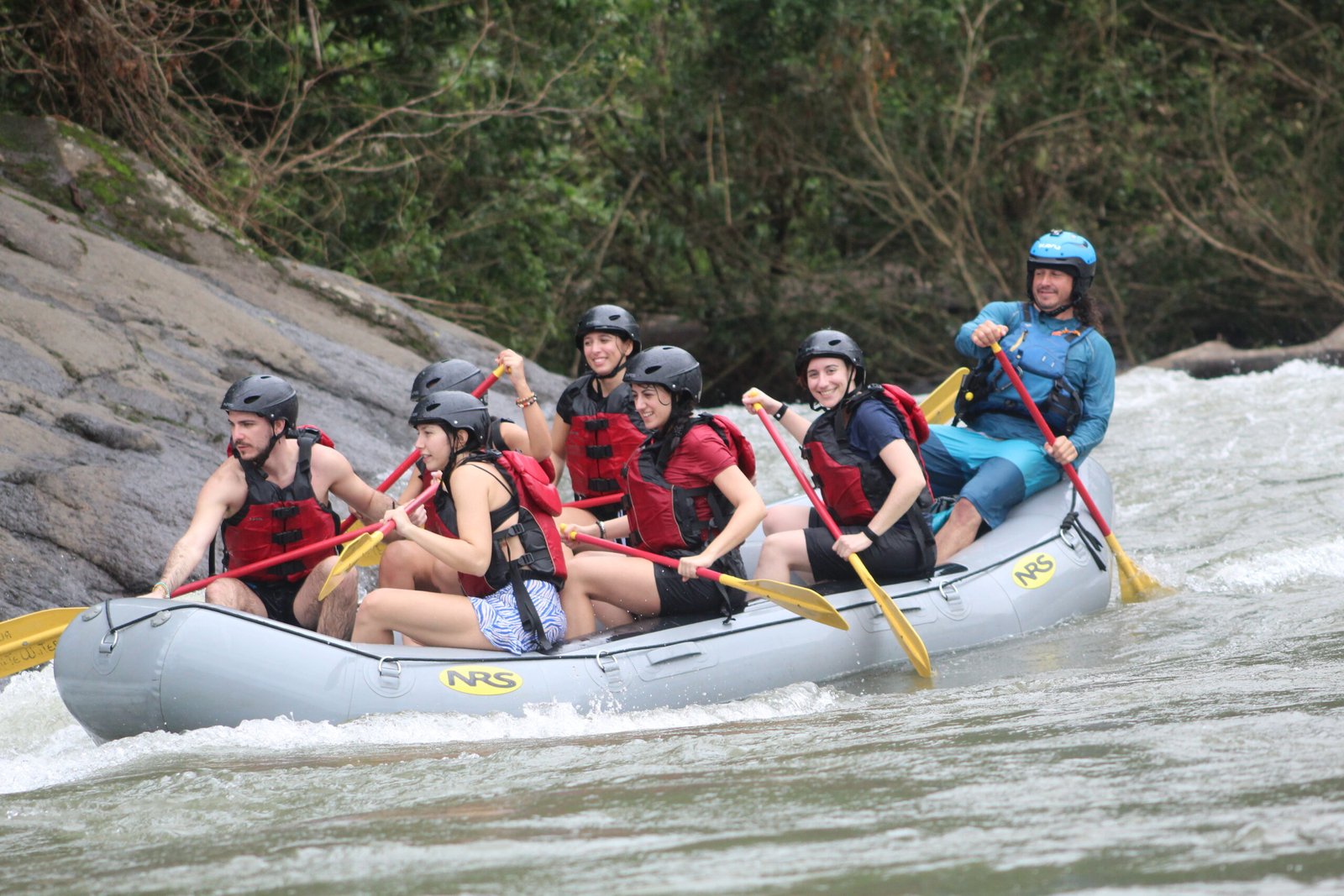 family rafting navigating sarapiqui river with friends